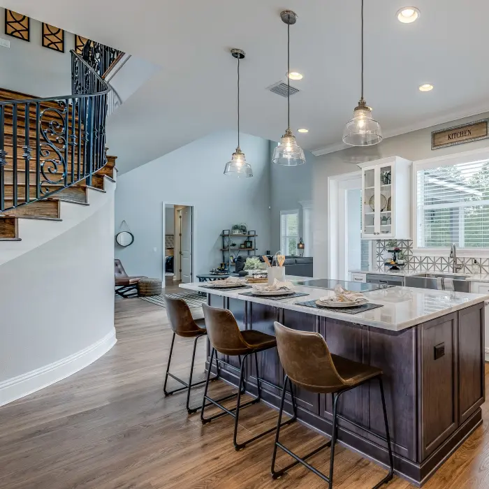 A beautiful kitchen island with a view of a great room.