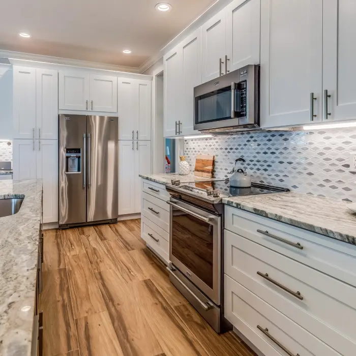 A modern kitchen showcasing sleek cabinetry, stainless steel appliances, and an inviting atmosphere perfect for culinary creativity and family gatherings.