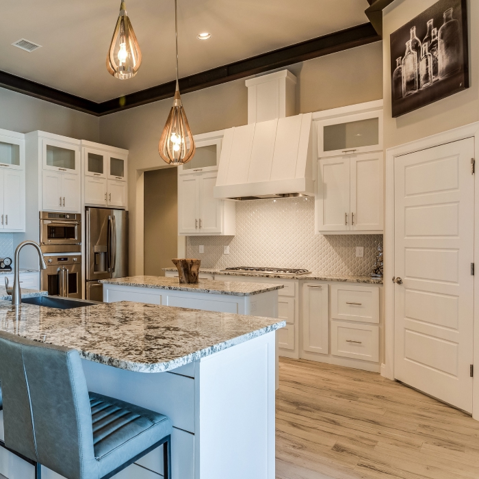 Beautiful kitchen with double island, decorative tile and french door oven